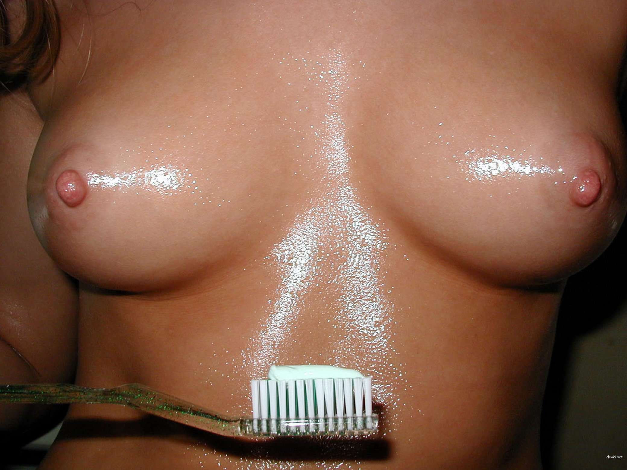 Amateur Babe Teases Wet Pussy with Toothbrush - Explicit Solo Masturbation Photo